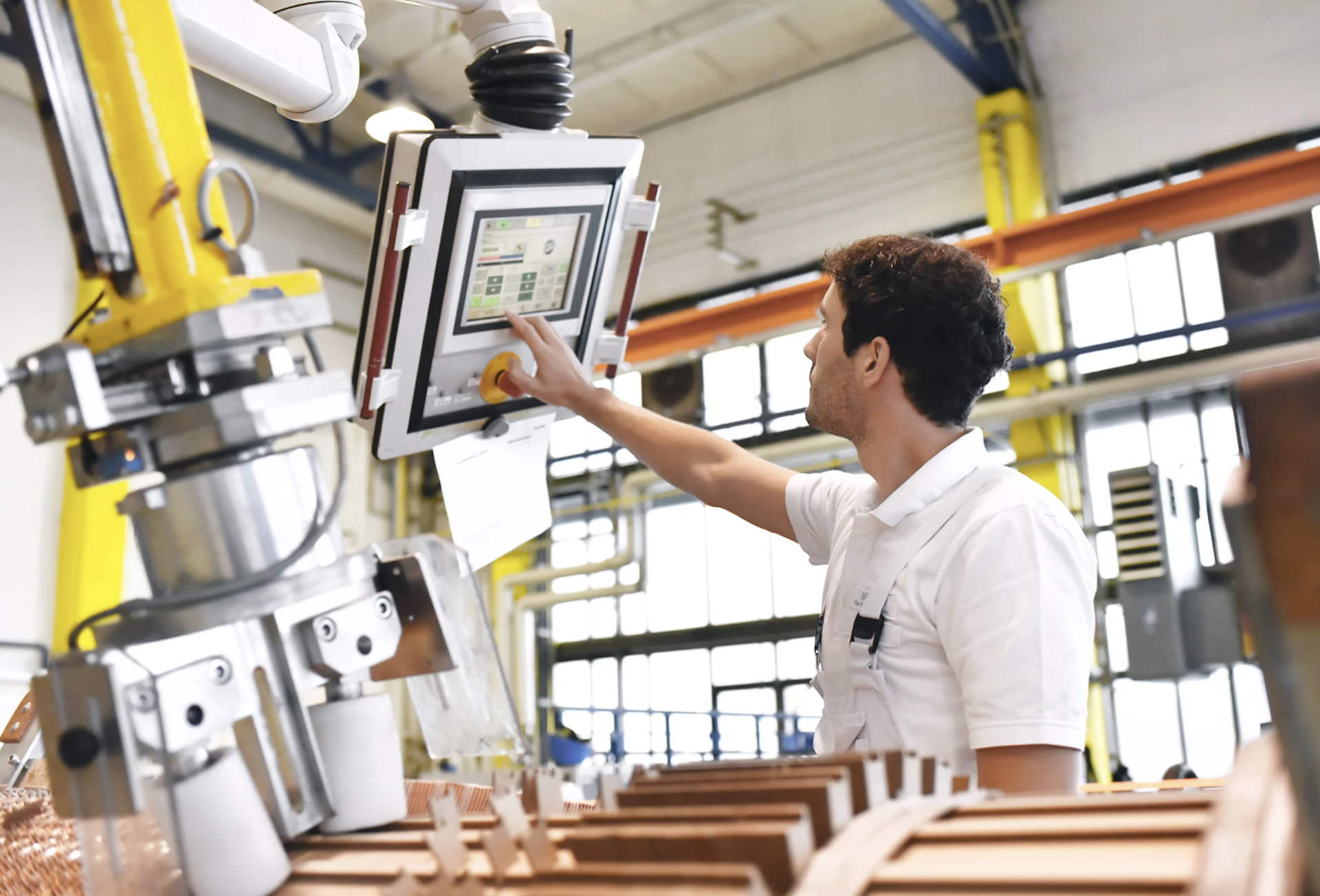 Man using a computer aided equipment at a custom manufacturing business